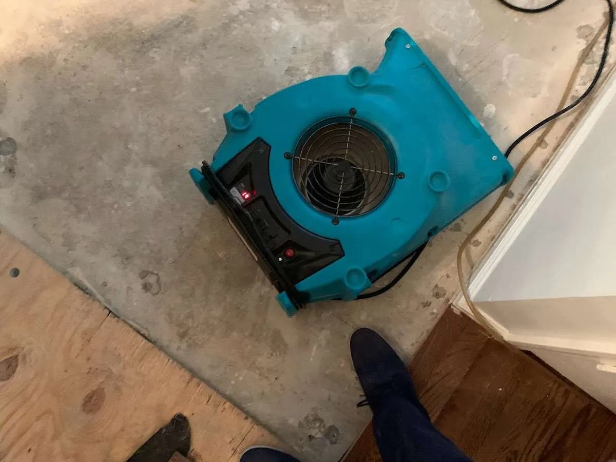 Air mover drying subfloor during Commercial Water Damage Restoration in Merritt Island